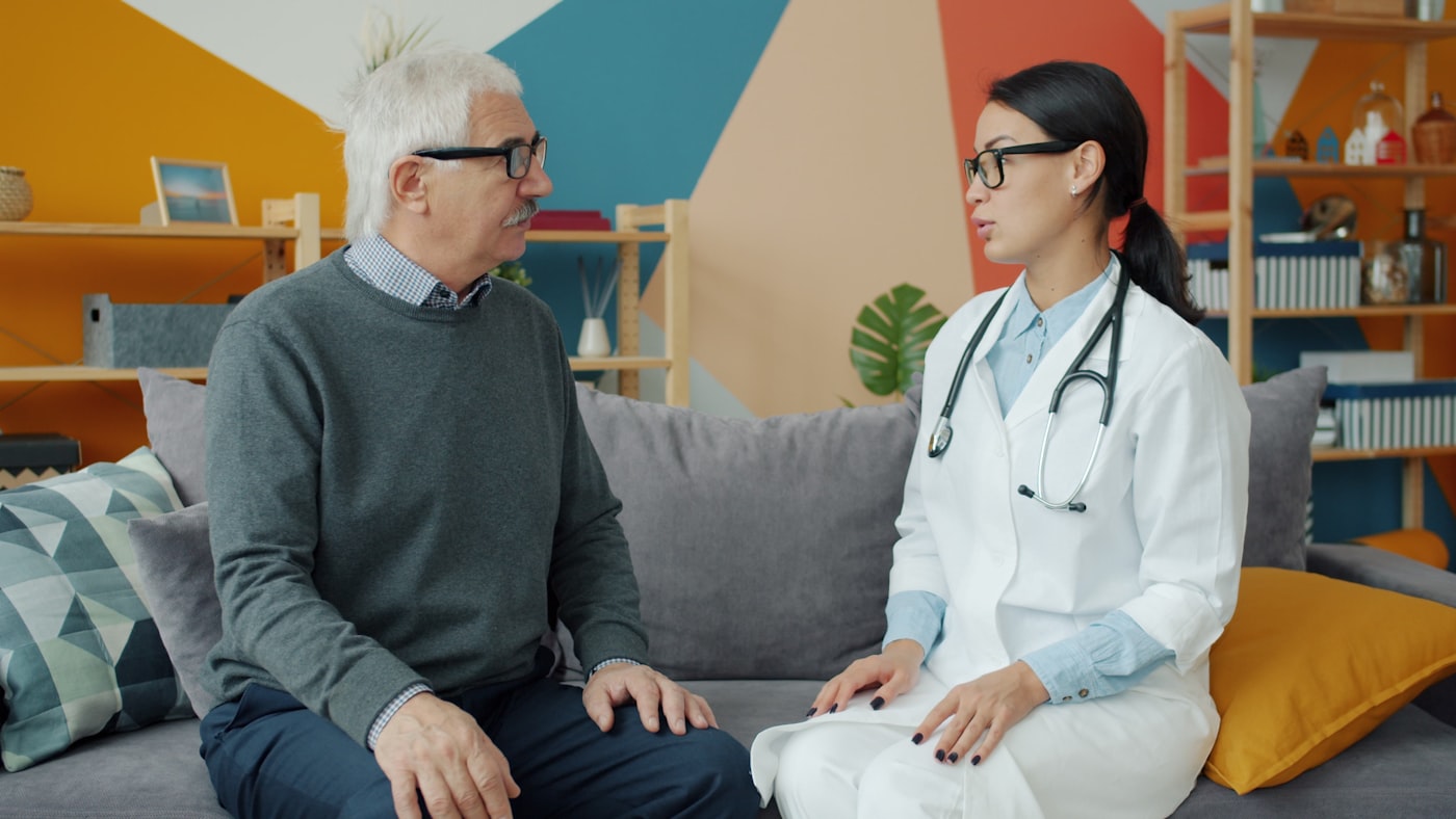 Doctor visiting an elderly patient at home