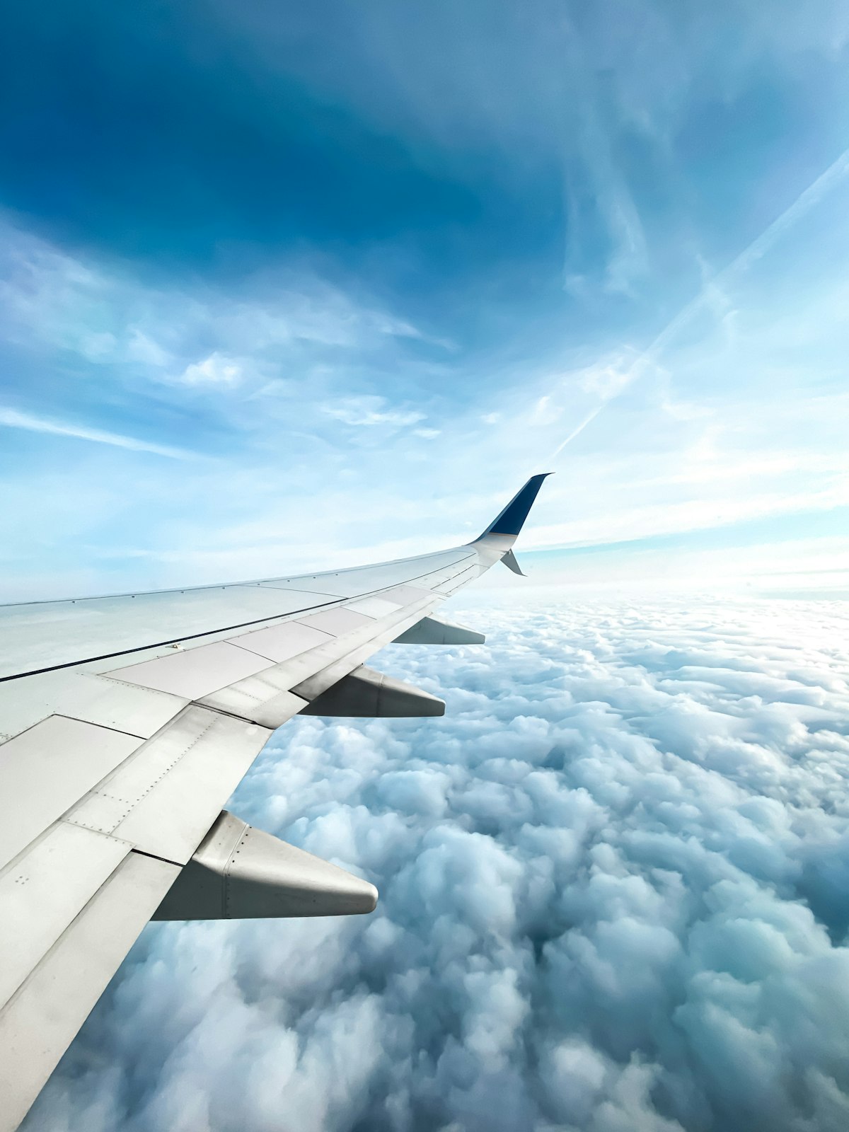 Aircraft wing above the clouds — international medical repatriation